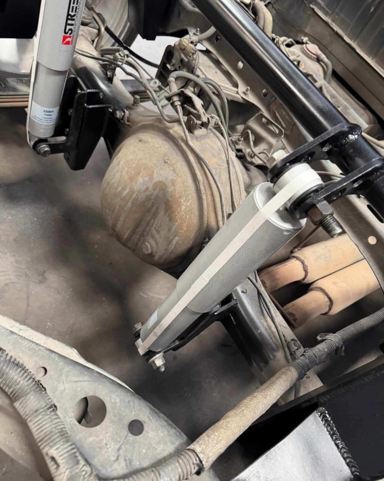 Adjustable shock relocation brackets