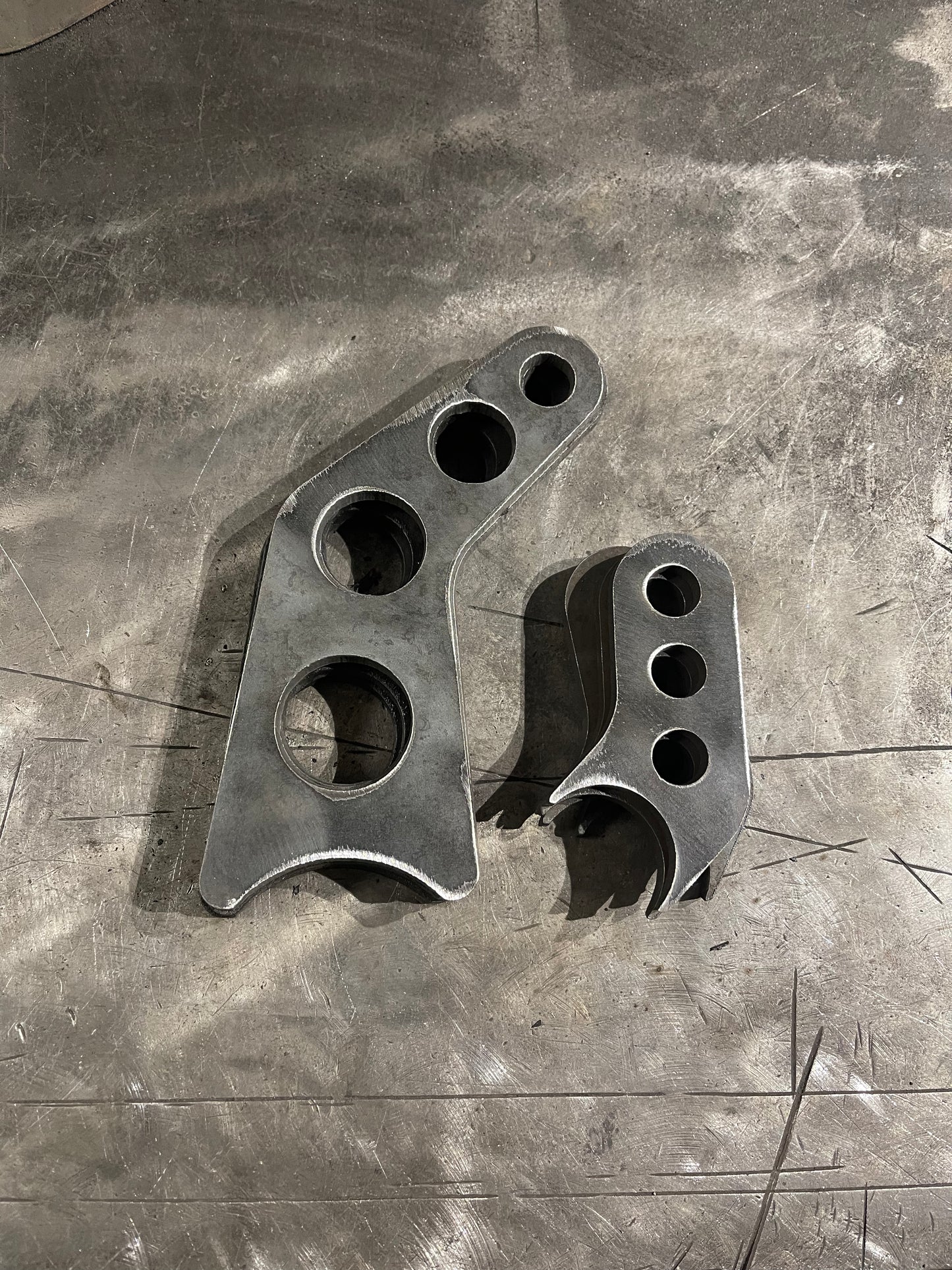 Shock relocation brackets